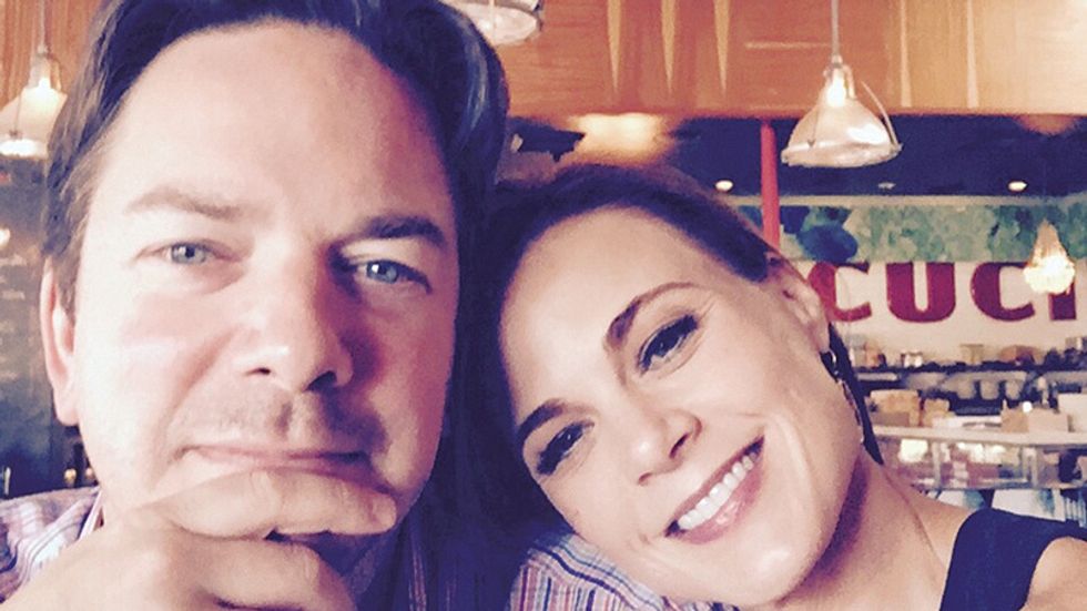 Gina Tognoni and husband take a selfie in a deli.