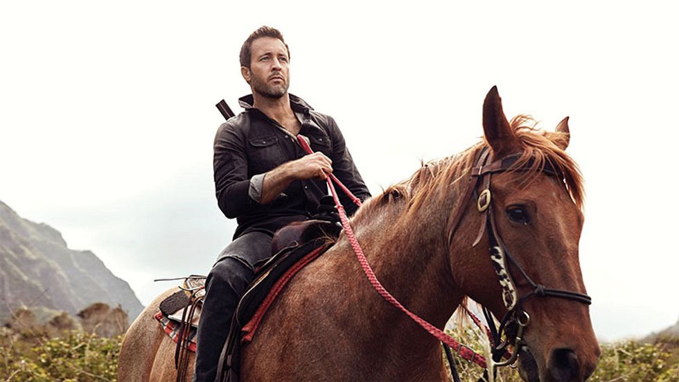 Alex O'Loughlin wears a leather jacket and pants while riding horseback.