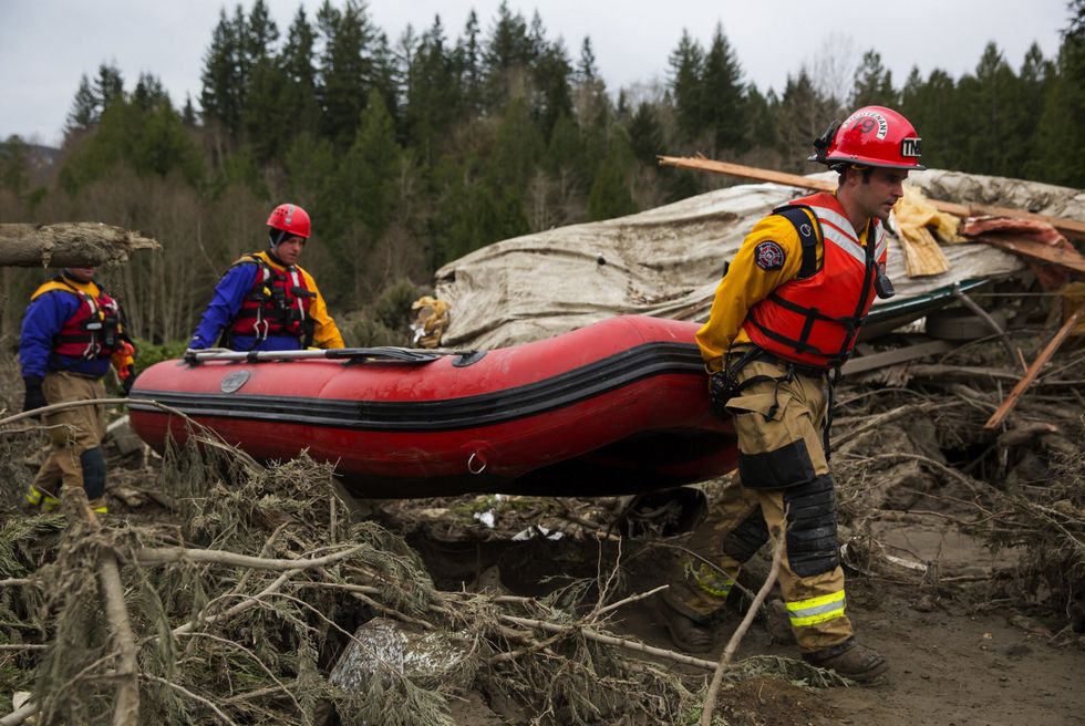 Volunteers Join Search Of Mudslide Site For Signs Of Life