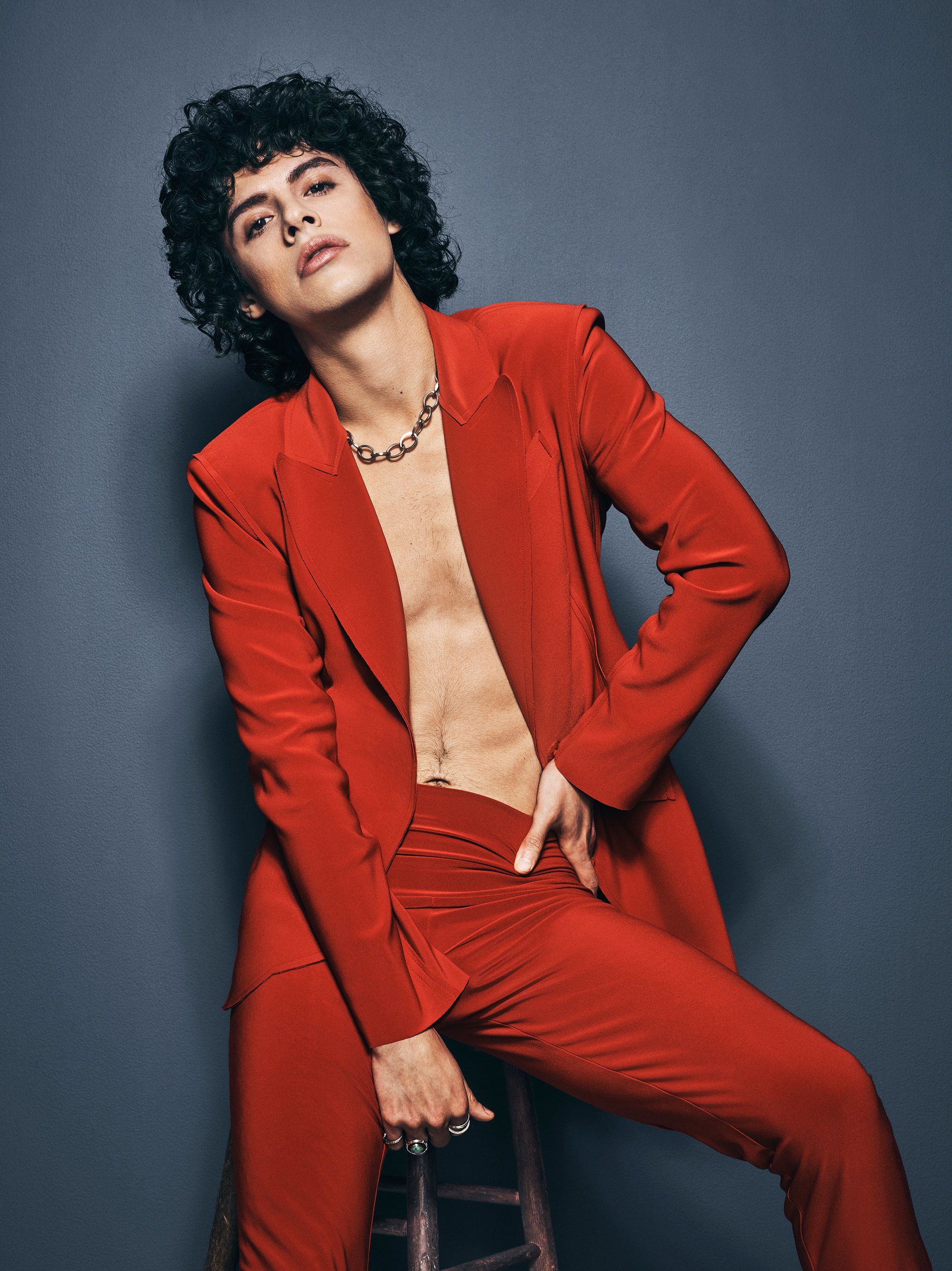 Jonny Beauchamp in a red suit with no shirt.