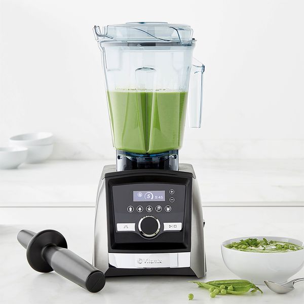 Vitamix blender with a green smoothie.