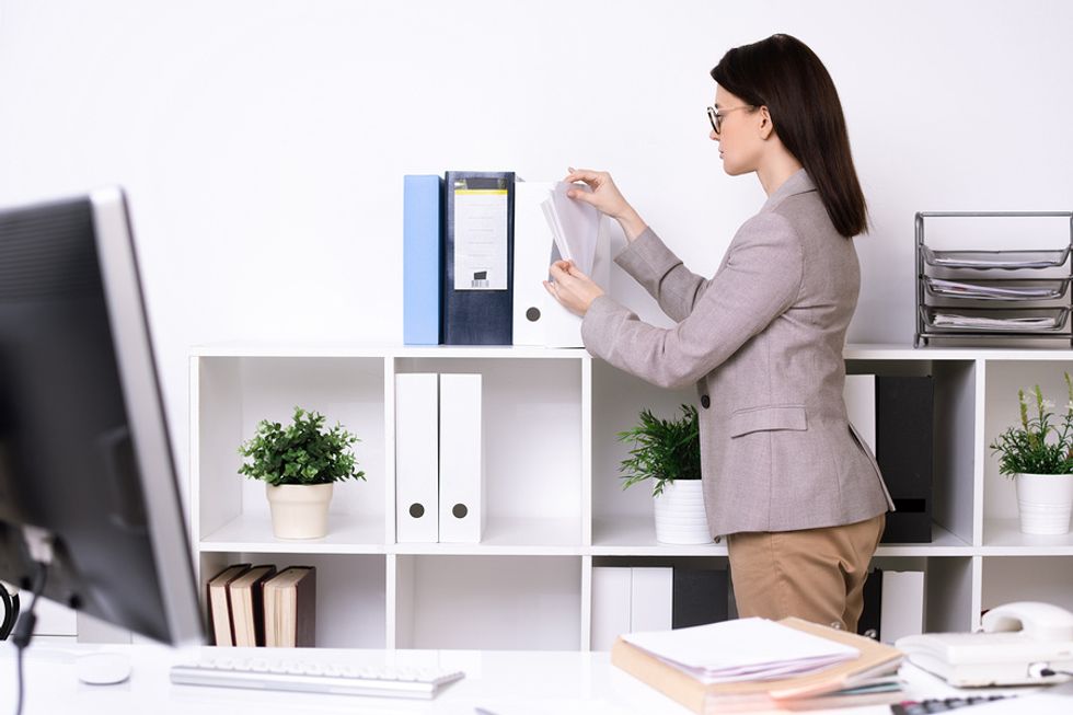 Professional woman uses desk organizers to keep her workspace clean