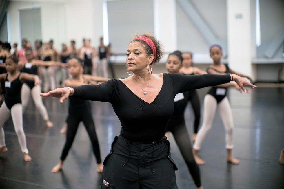 Debbie Allen teaching a class of young girls, mostly black, in center work.