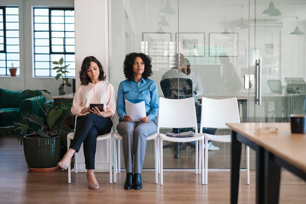 Two working women wait for a job interview