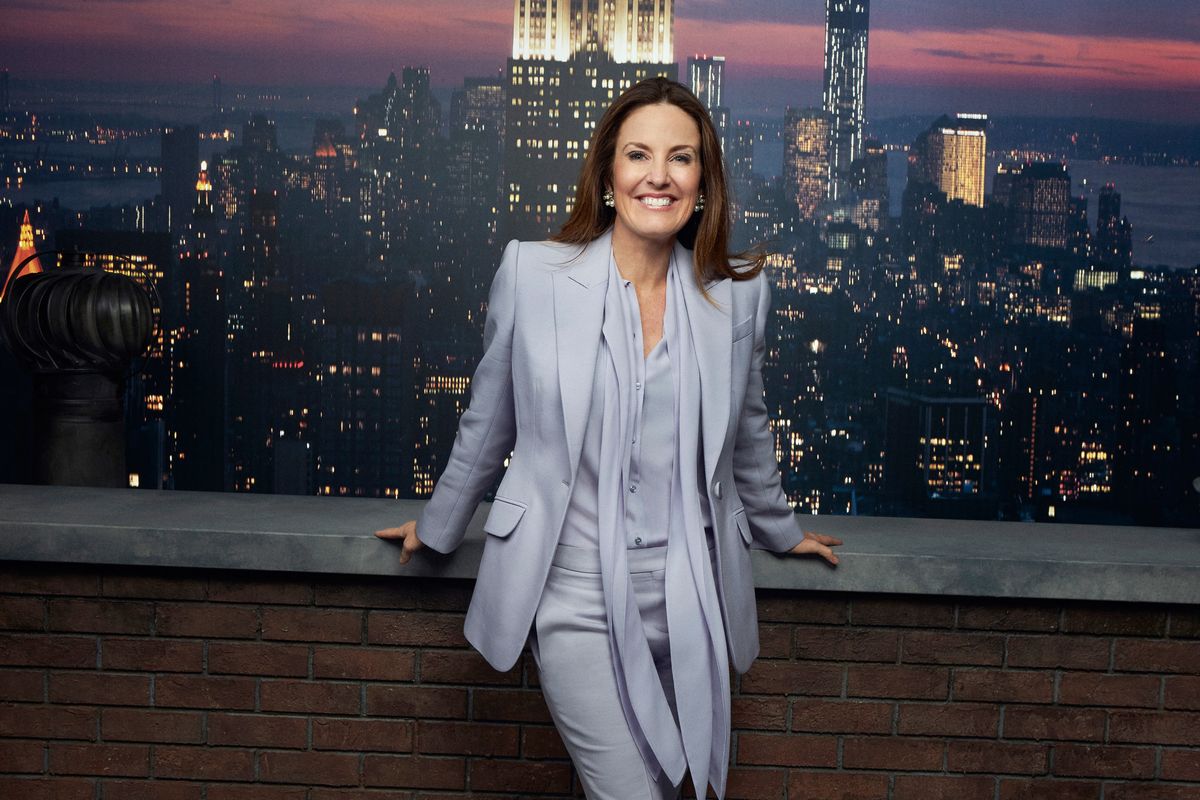 Sharyn Alfonsi posing in front of a Manhattan skyline backdrop.