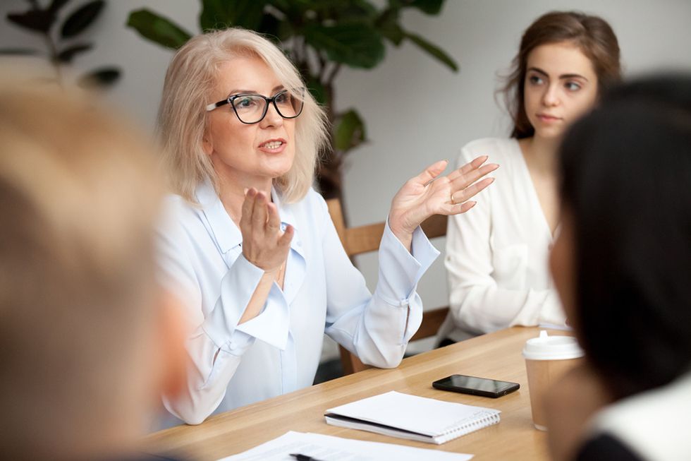 A manager explains the company's plans to a group of employees.