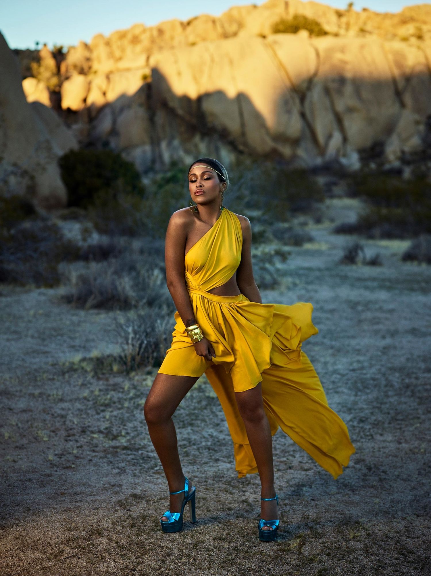 Eve of The Talk in a one shouldered yellow dress and blue shoes