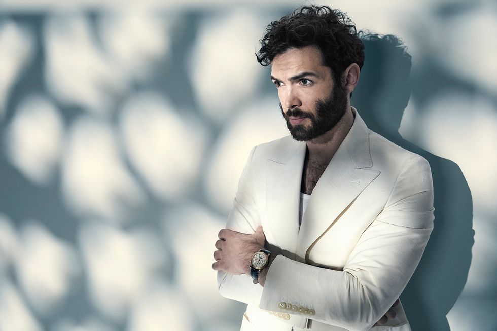 Ethan Peck of Star Trek Discovery in a white jacket and tank top