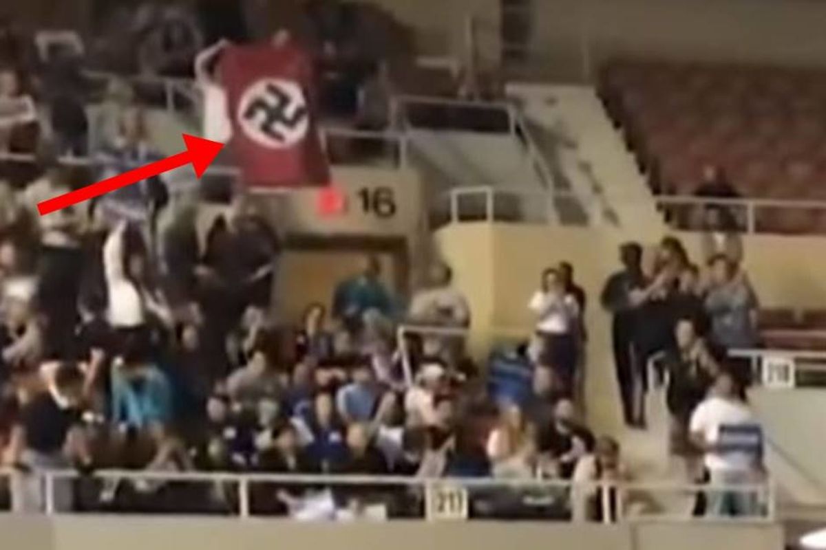 Bernie Sanders reacts to the 'horrible' Nazi flag waved by a protester at his rally