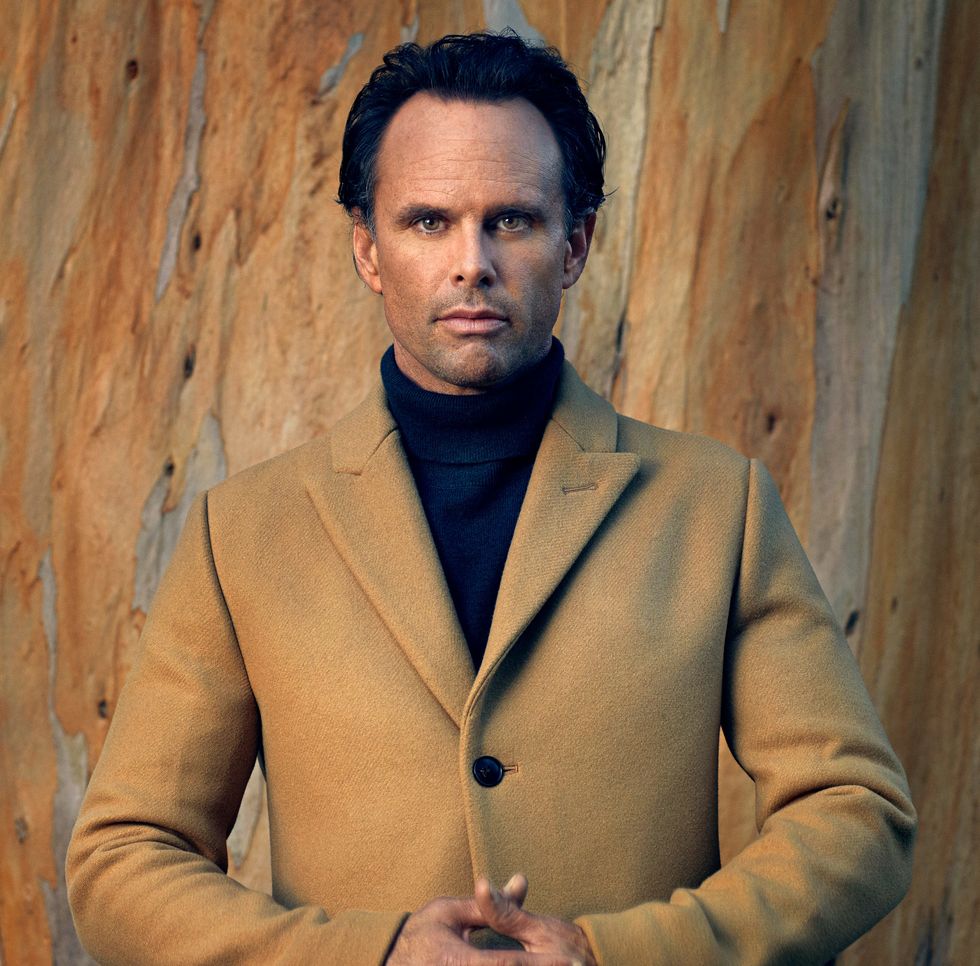 Walton Goggins headshot looking into the camera wearing a tan wool coat.