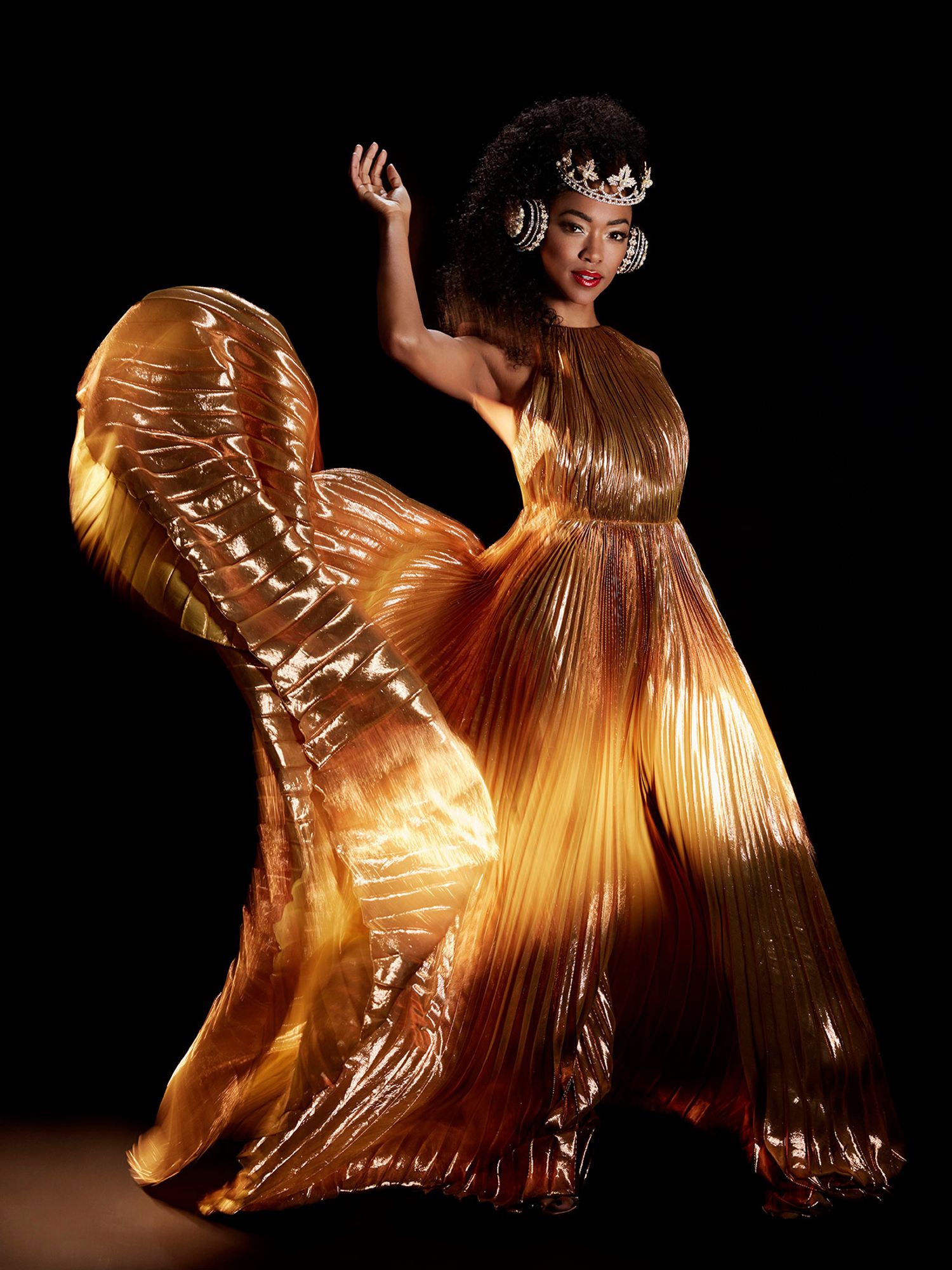 Sonequa Martin Green in a golden dress and crown