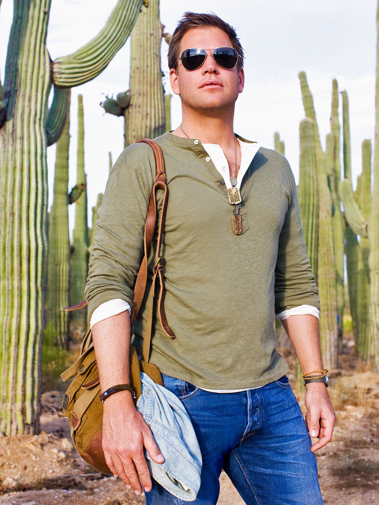 Michael Weatherly in a green shirt standing in front of cacti