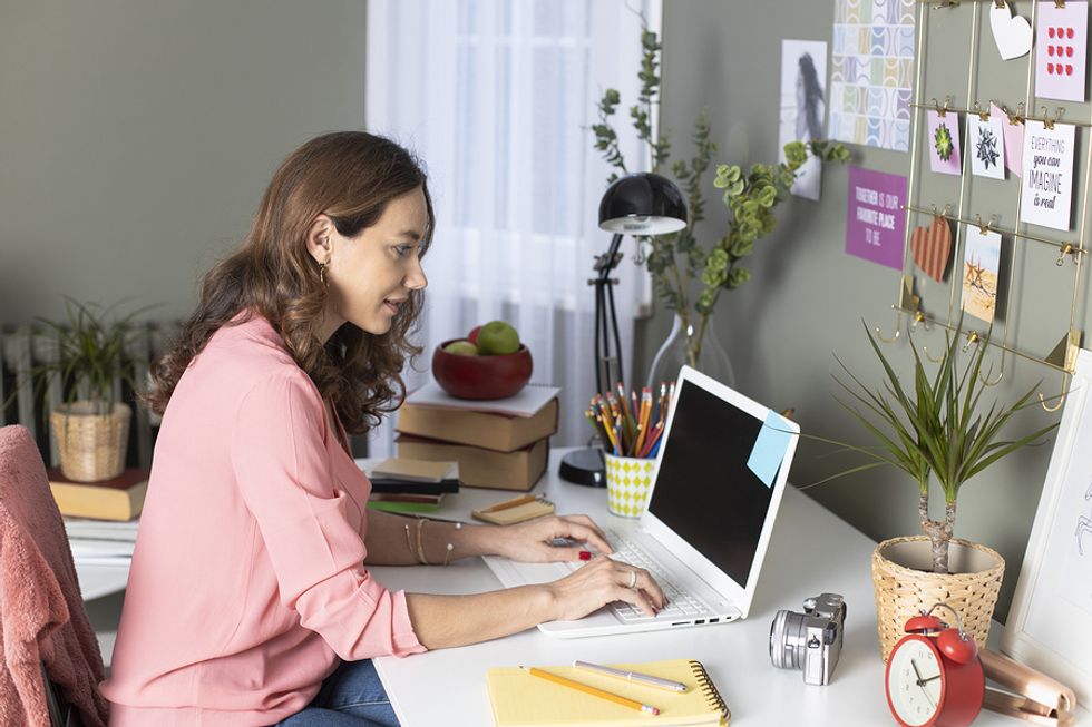 Woman sets up an office to work from home during the coronavirus pandemic