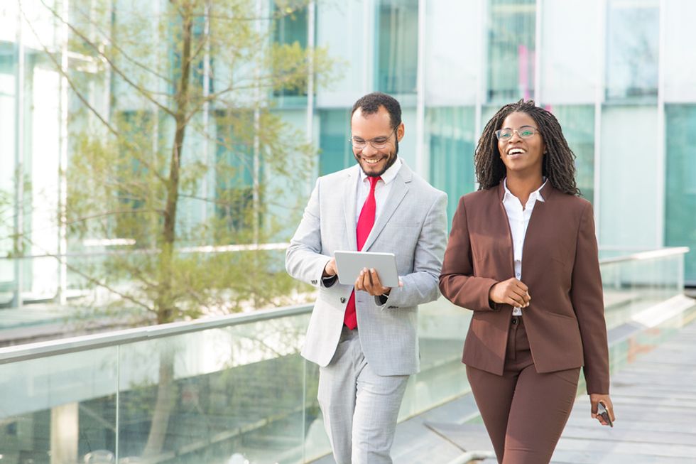 Two co-workers take a walk to get enough vitamin D