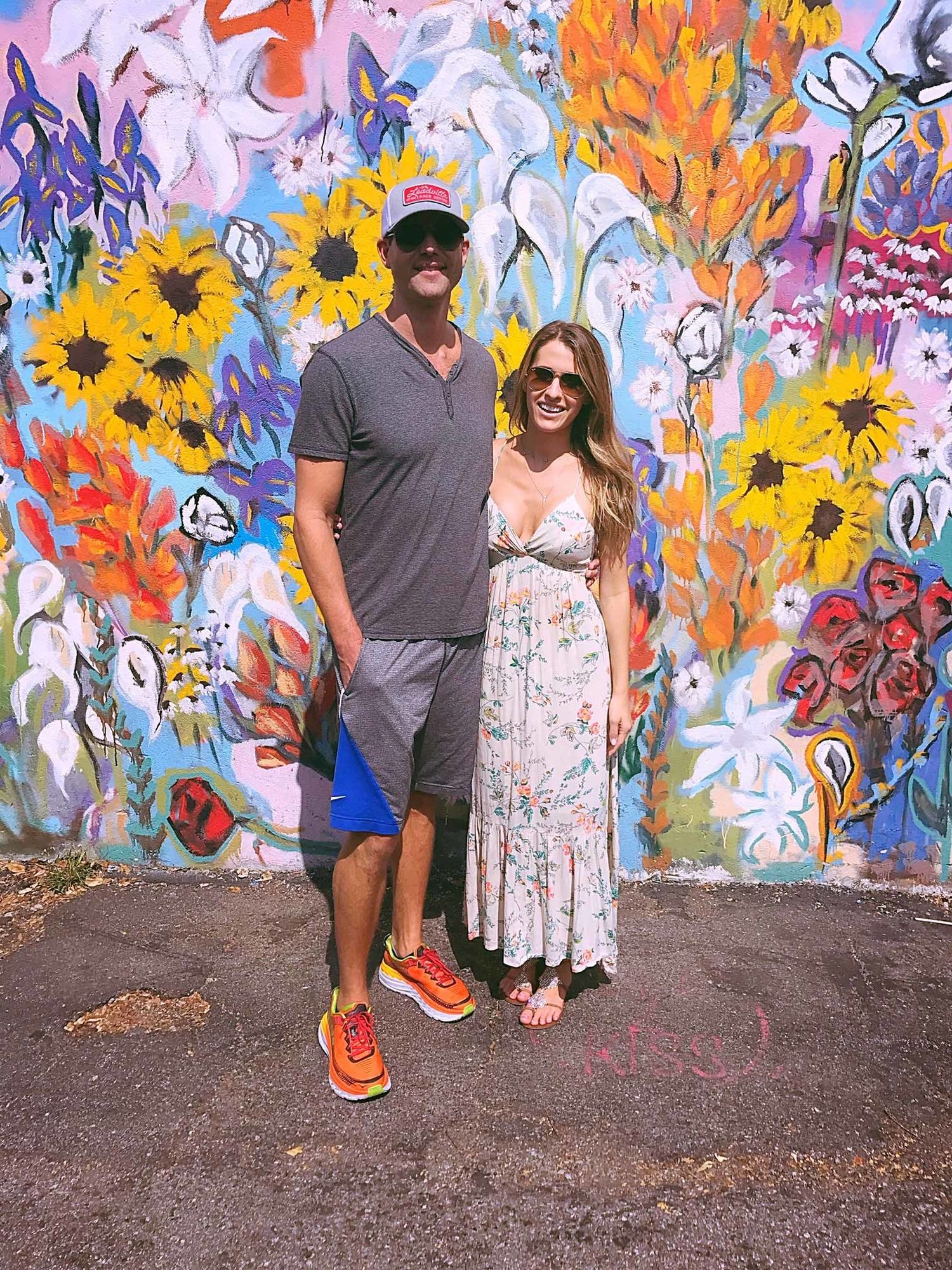 Dr. Travis Stork and his wife in front of a mural in Nashville.