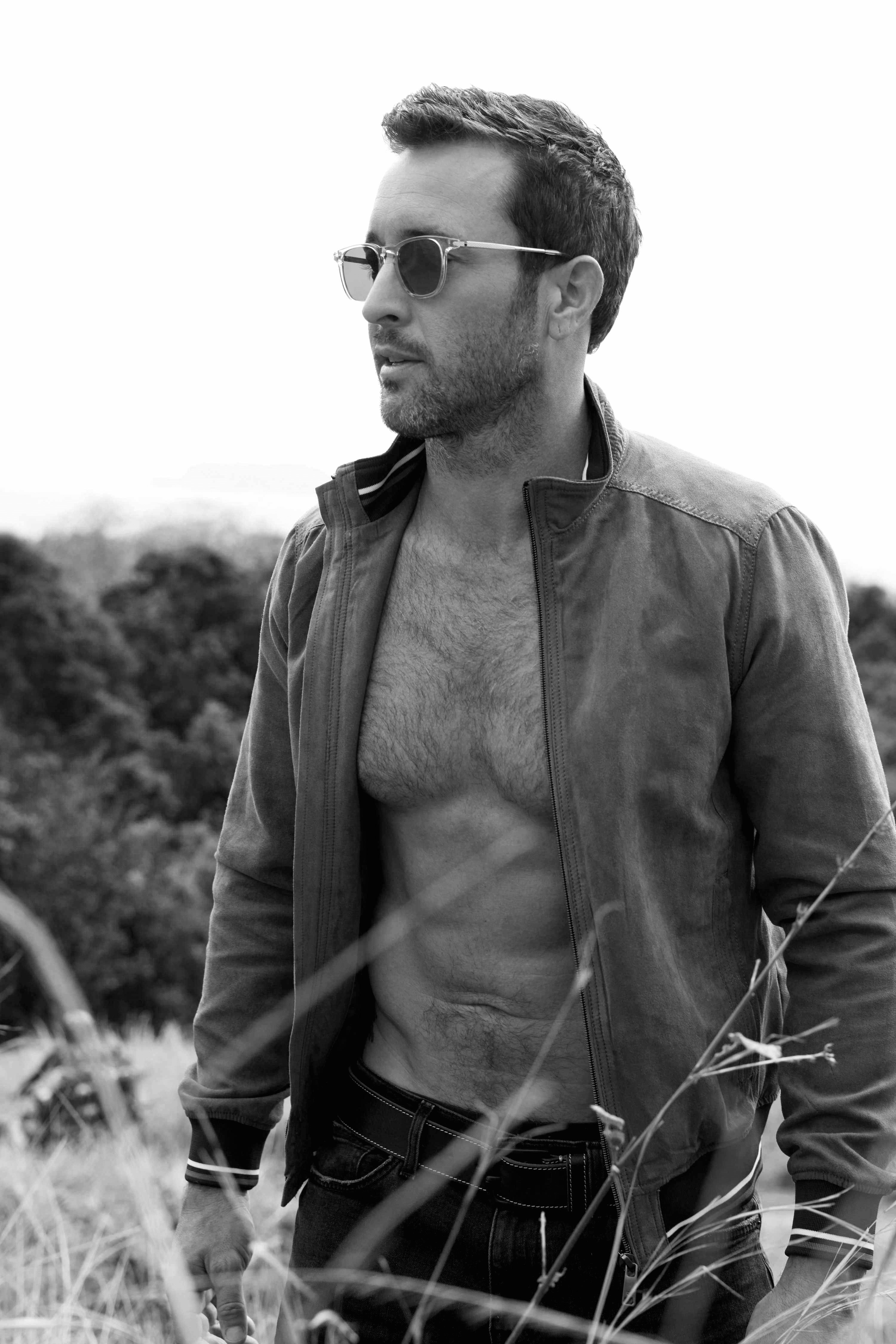 Black and white photo of Alex O'Loughlin shirtless