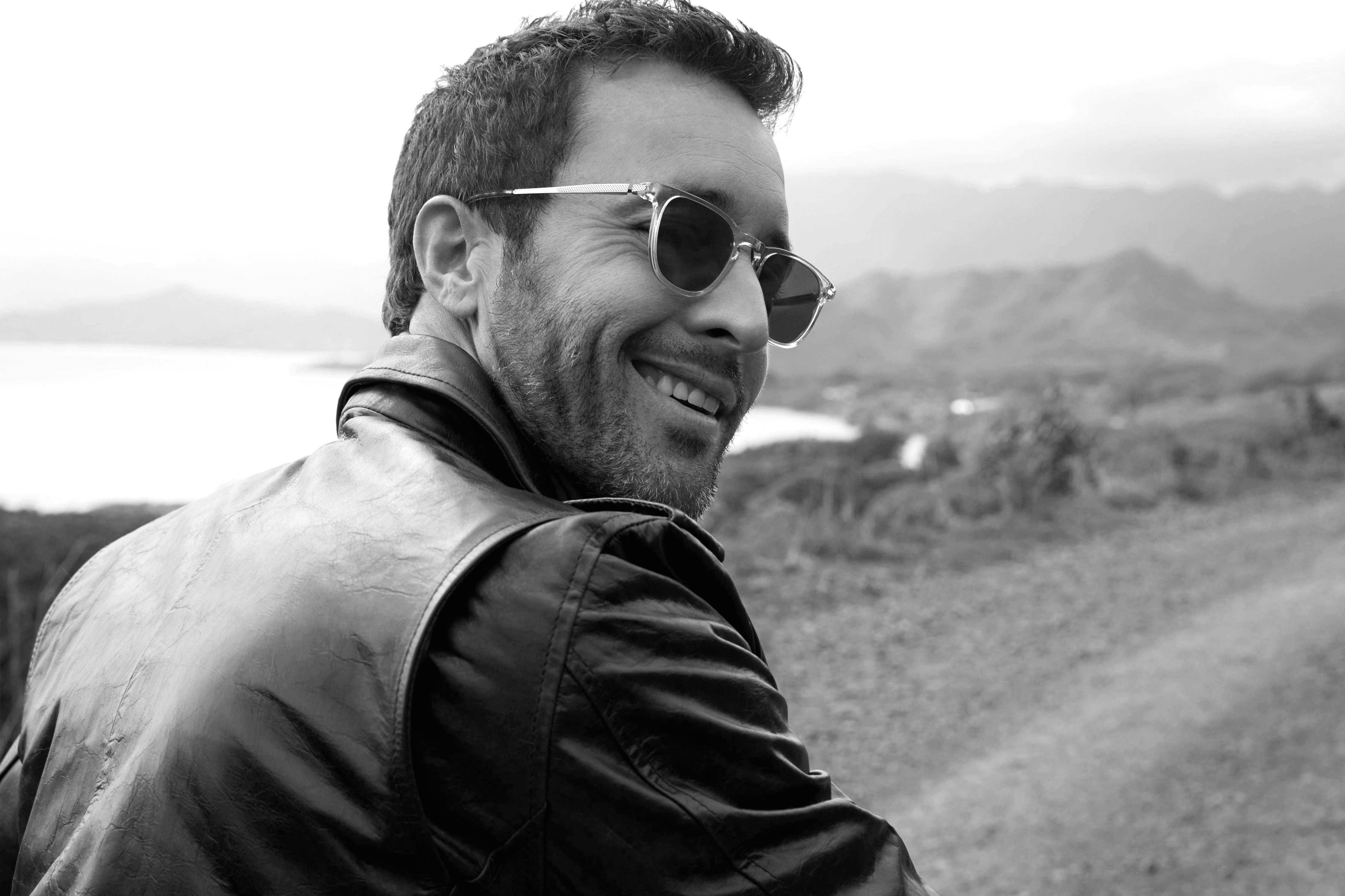 Alex O'Loughlin smiling wearing sunglasses
