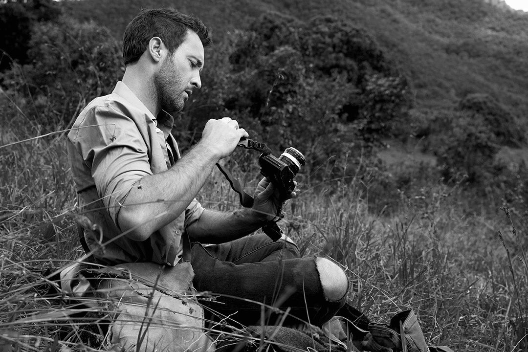 Black and white photo of Alex O\u2019Loughlin holding a camera
