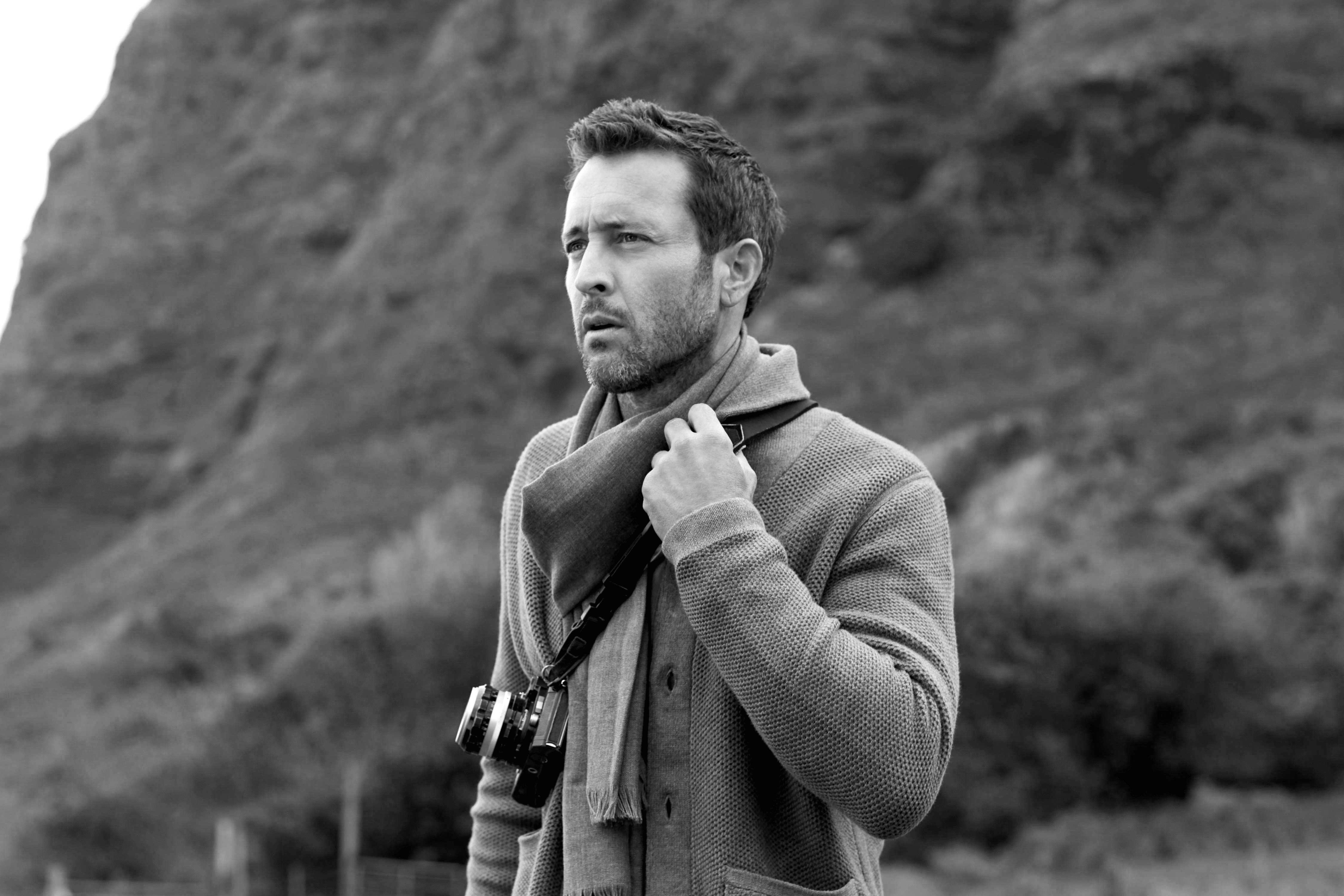 Black and white photo of Alex O'Loughlin wearing a scarf