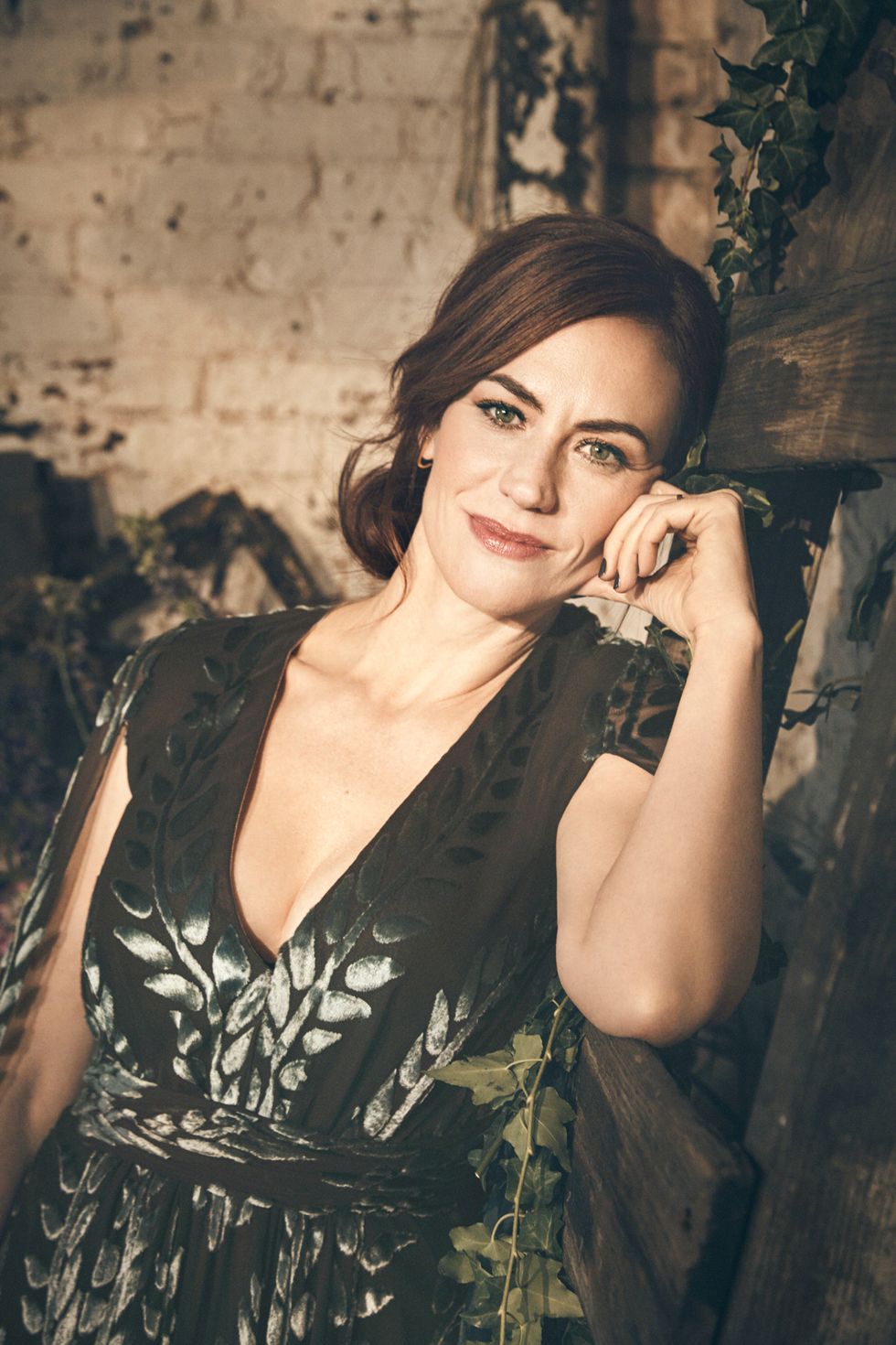 Closeup of Maggie Siff in a floral dress.