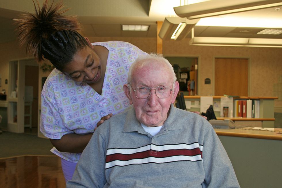 A health care worker checks on a patient.