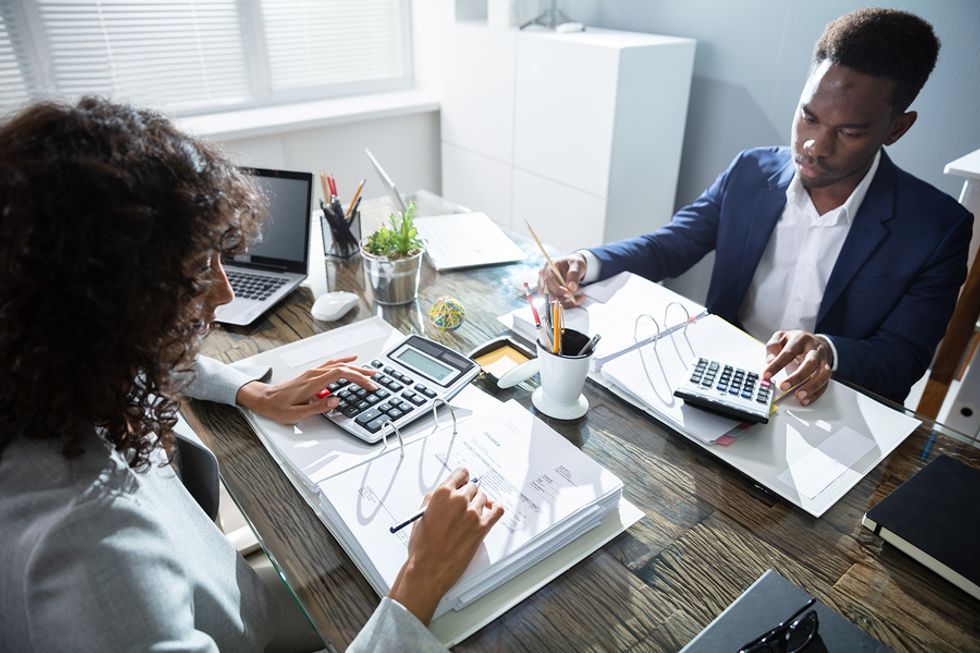 Two business owners do their taxes