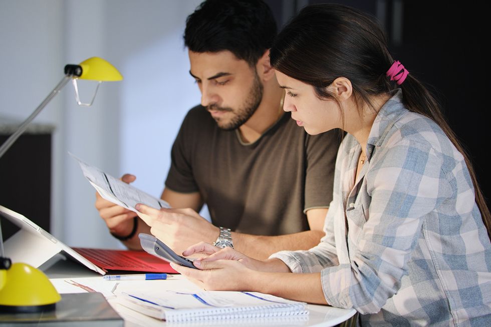 Man and woman do taxes for their digital business