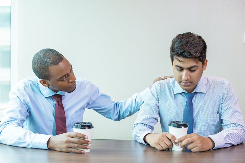 A supervisor offers support to one of his employees.