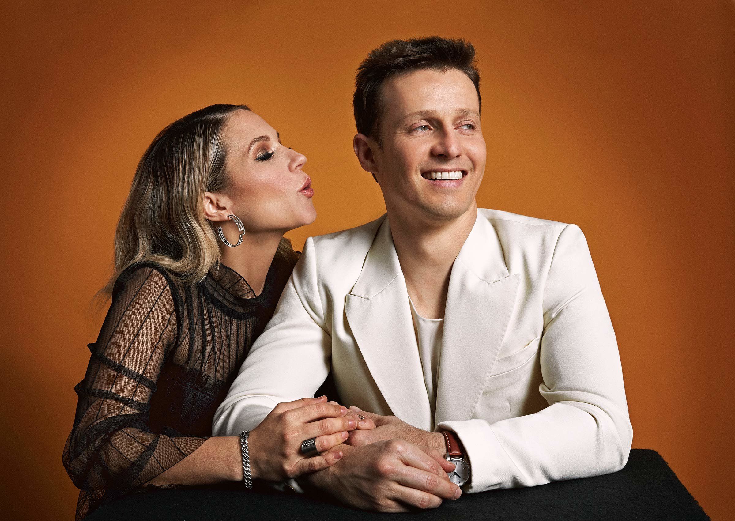 Vanessa Ray in a black dress and Will Estes in white suit.