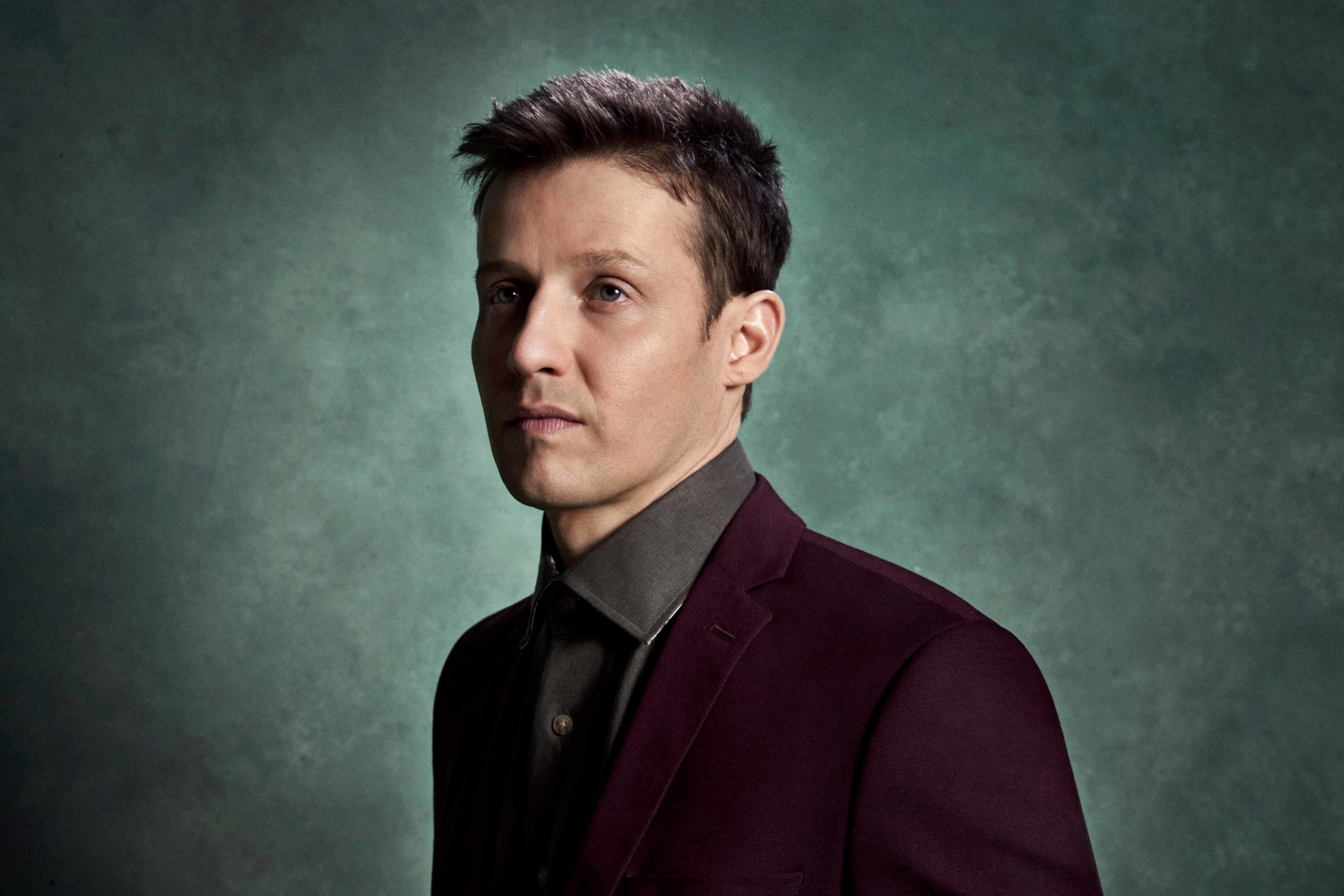 Will Estes wearing a burgundy blazer