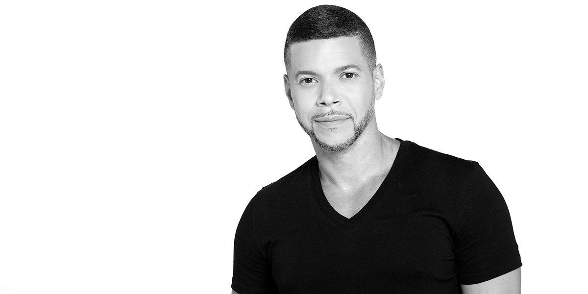 Wilson Cruz in a black t-shirt.