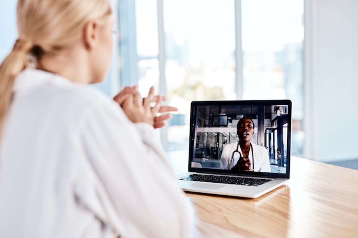 A patient talking to a doctor on a computer