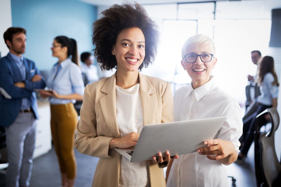 Two software managers smile at the camera