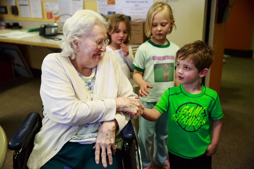 Preschoolers, Seniors Work Together At Day Care Inside Retirement Home