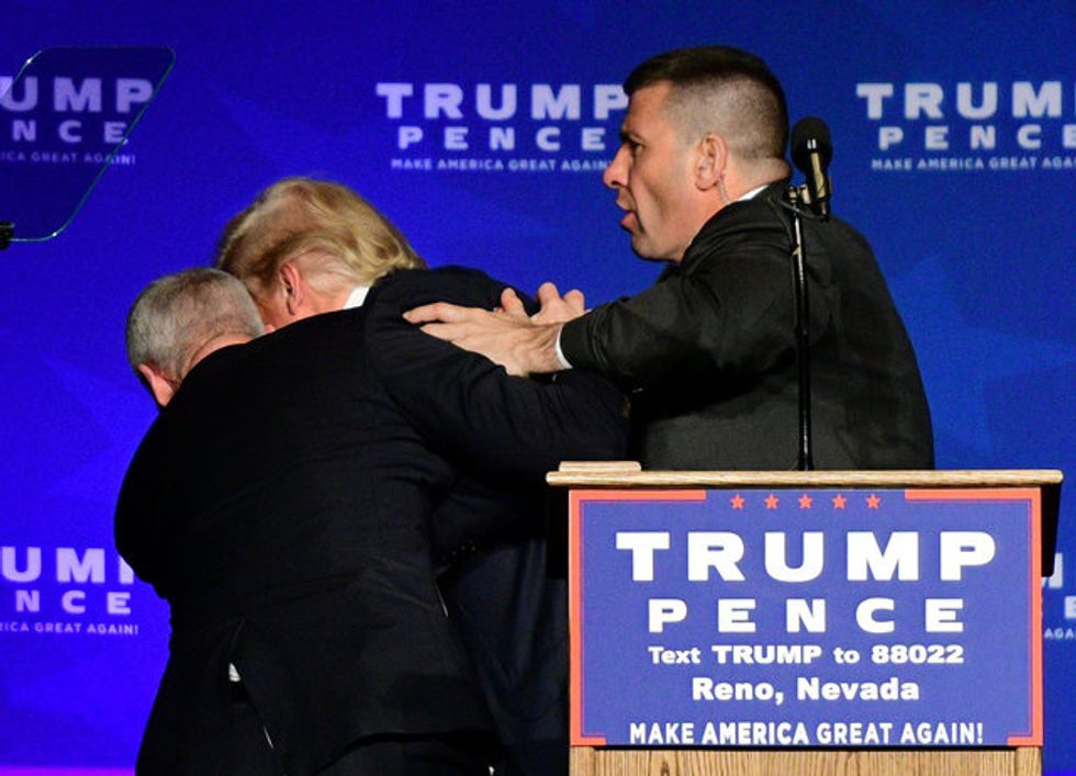 Security Hustles Trump From Stage After Protester Displays Sign