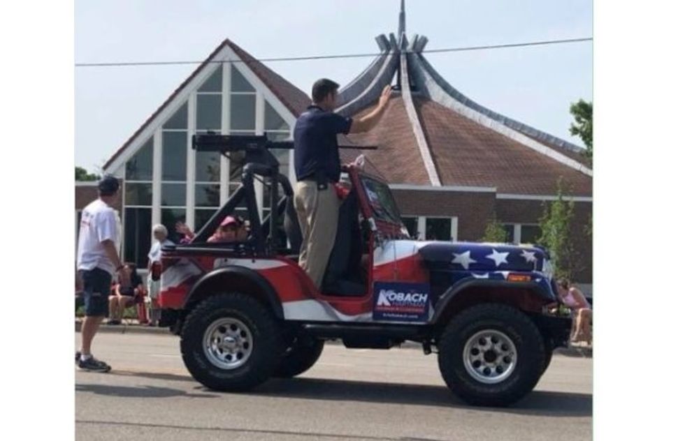 Kris Kobach Stuns Kansas Parade Viewers With Machine-Gun Float