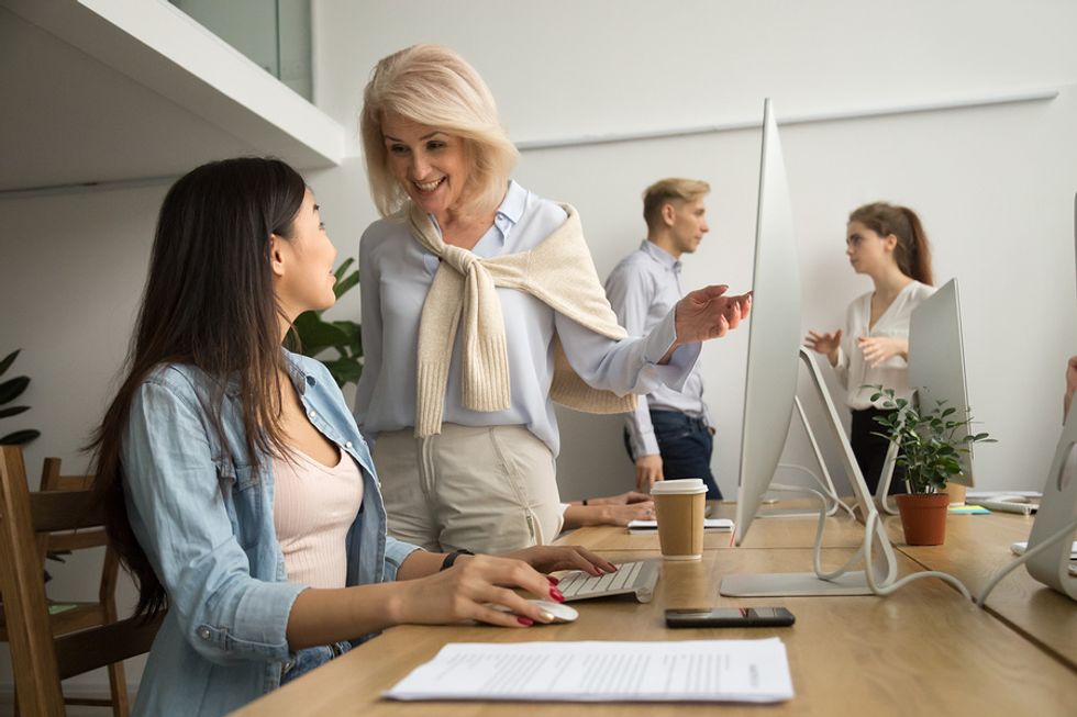 Woman smiles at a difficult co-worker