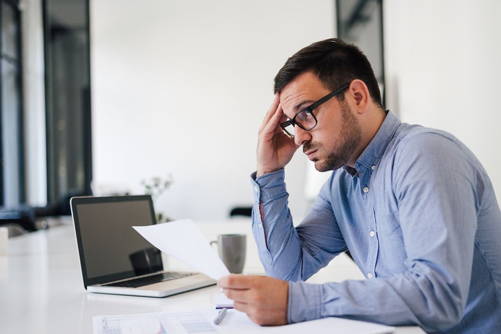 Stressed out man working at a job he took out of desperation