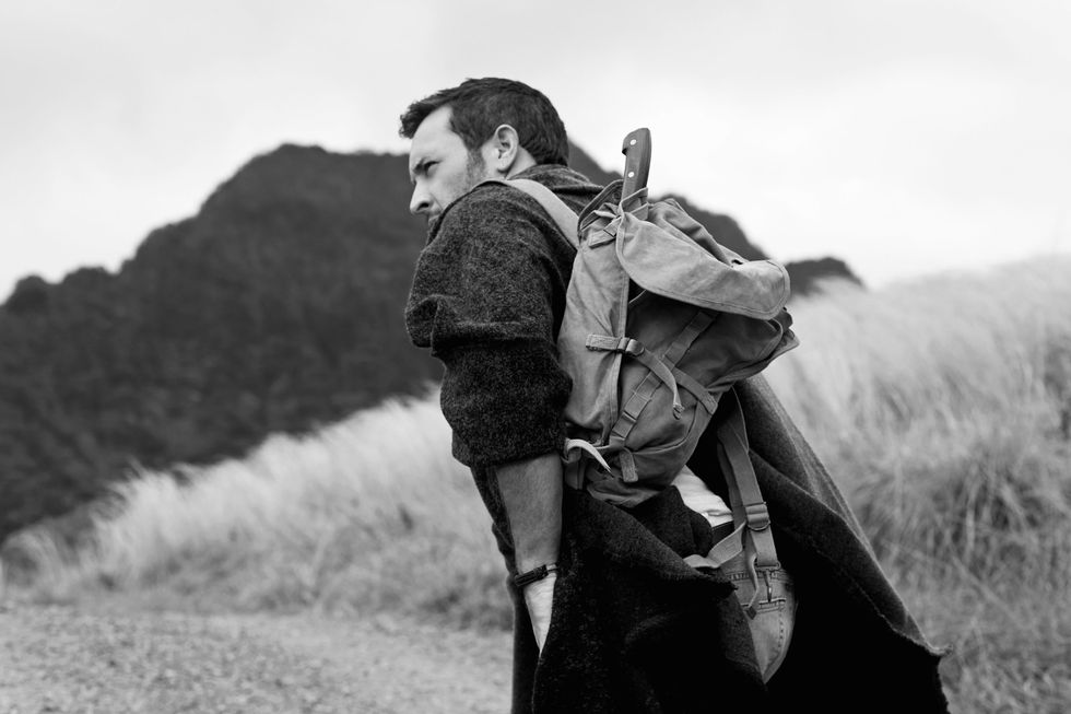 Black and white photo of Alex O'Loughlin hiking.