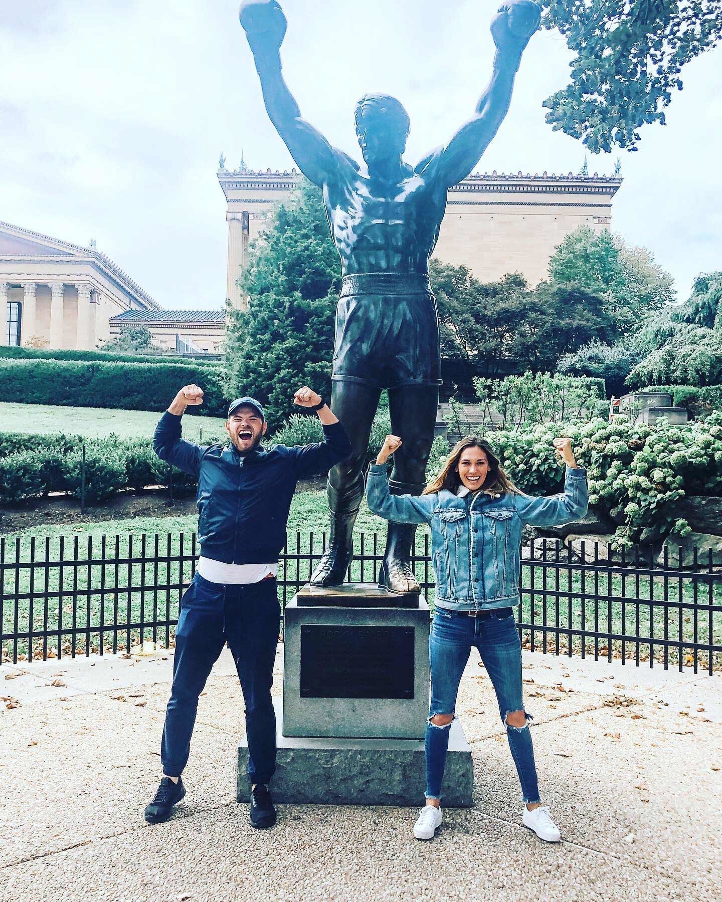 Kellan Lutz and wife in Philadelphia in front of Rocky statue.