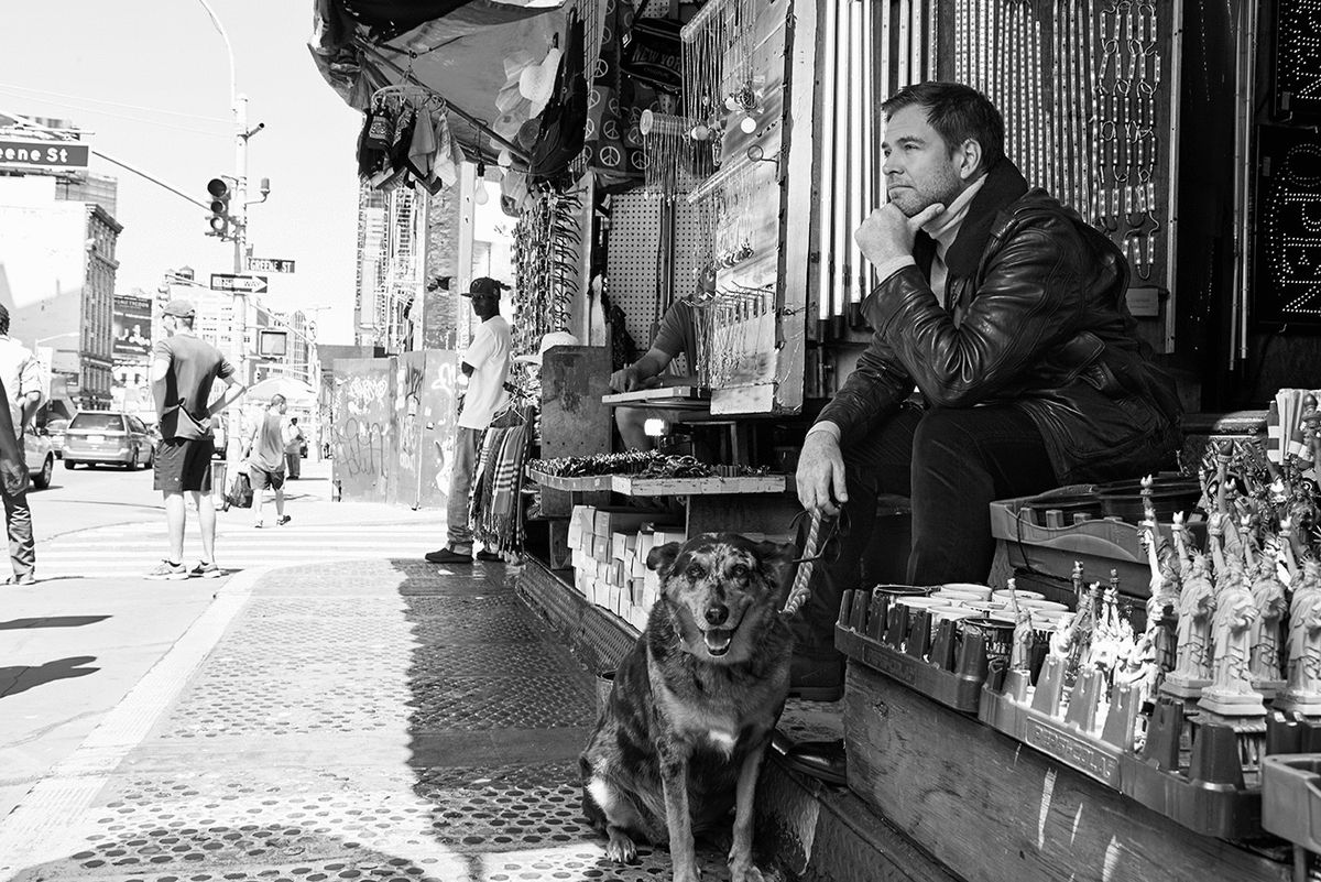 Black and white photo with Michael Weatherly and a dog in New York City.
