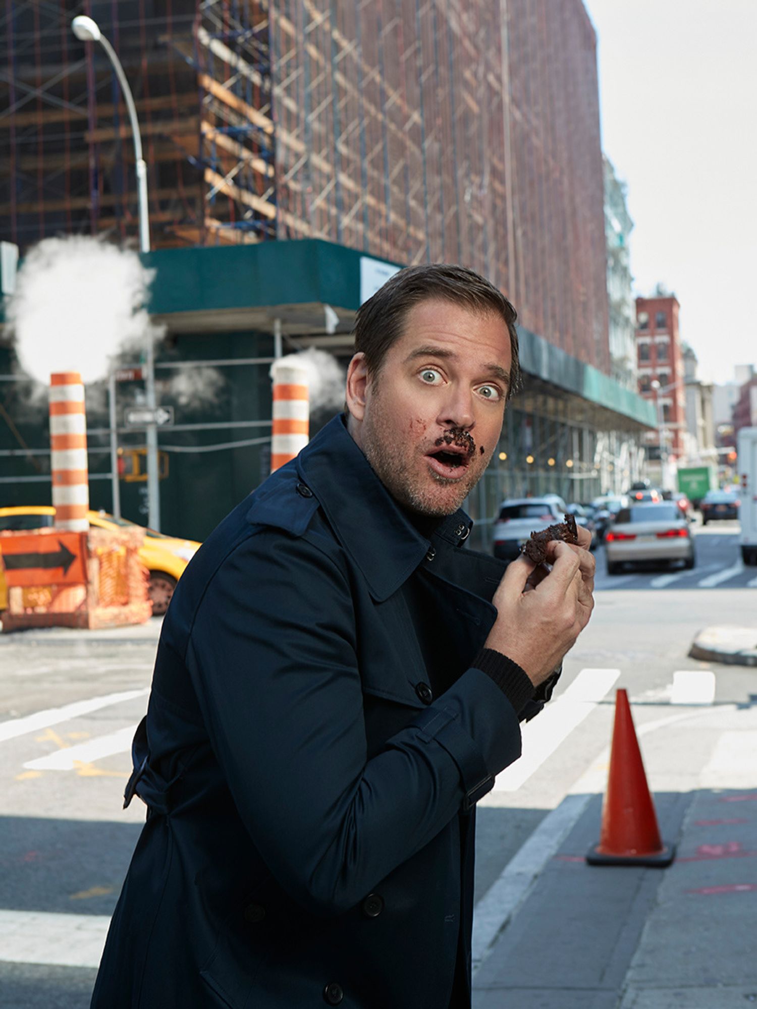 Michael Weatherly eating a cupcake with cake on his face.