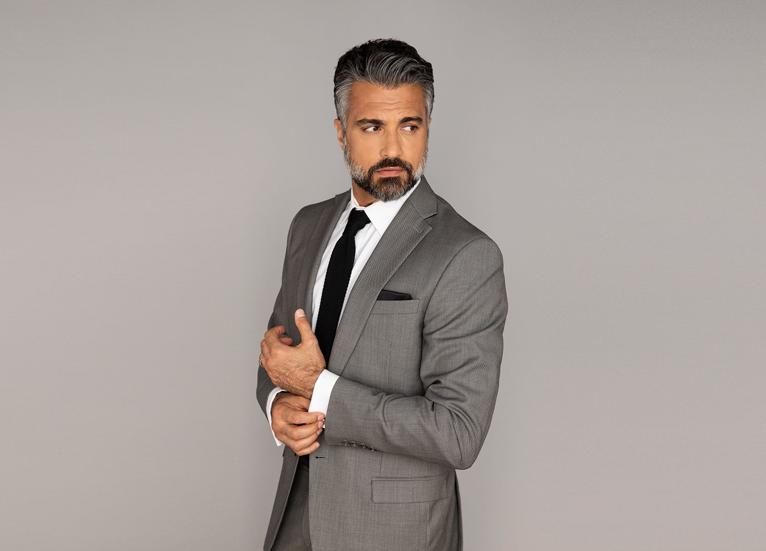 Actor Jaime Camil in a gray suit.