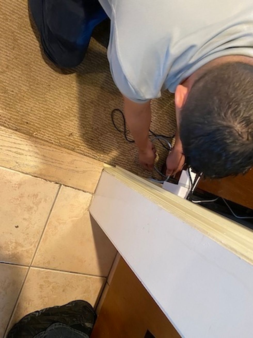 Control4 installing cable from home wi-fi router to control4 controller.