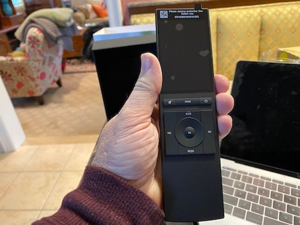 Neeo controller in a hand ready to be programmed.