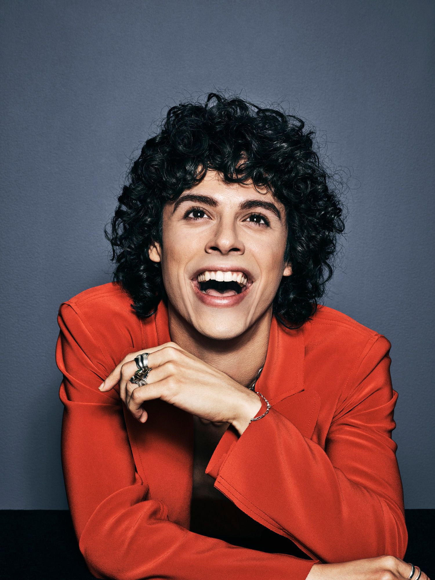 Jonny Beauchamp smiling and wearing a red jacket.