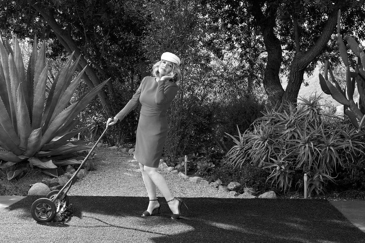 Melody Thomas Scott of The Young and the Restless pretending to use an old fashioned lawn mower