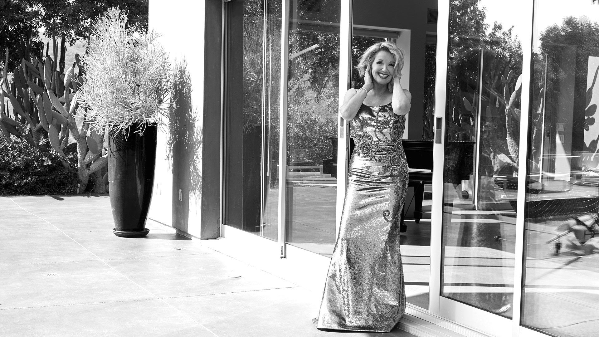 Melody Thomas Scott of The Young and the Restless in an evening gown on a patio