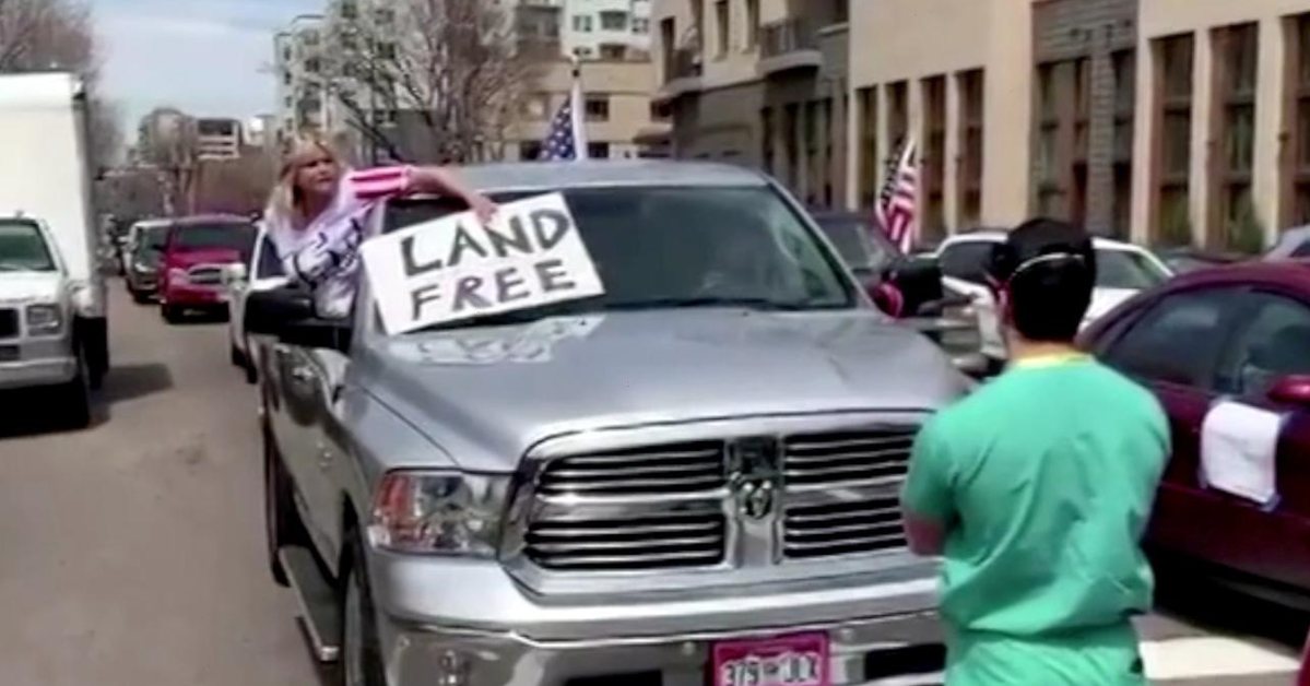 Healthcare worker stands peacefully as he's verbally abused by a right-wing stay-at-home protester