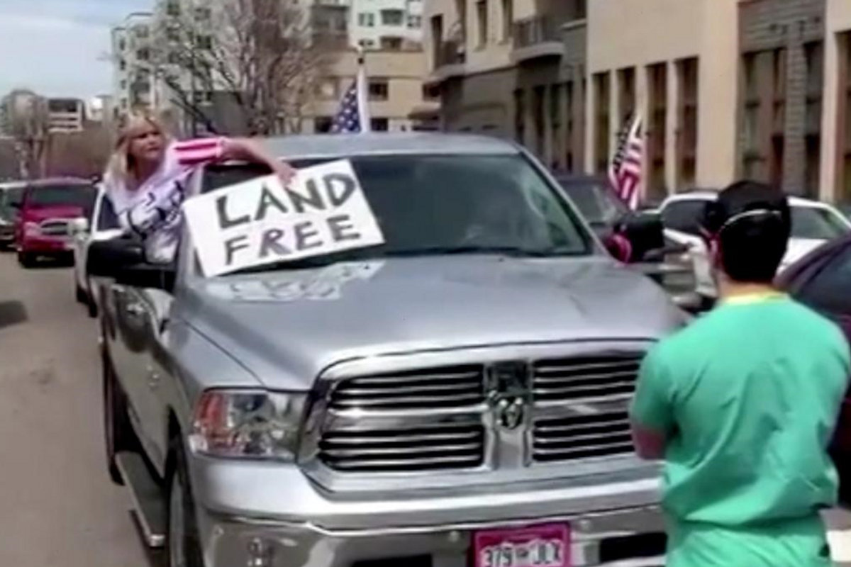 Healthcare worker stands peacefully as he's verbally abused by a right-wing stay-at-home protester